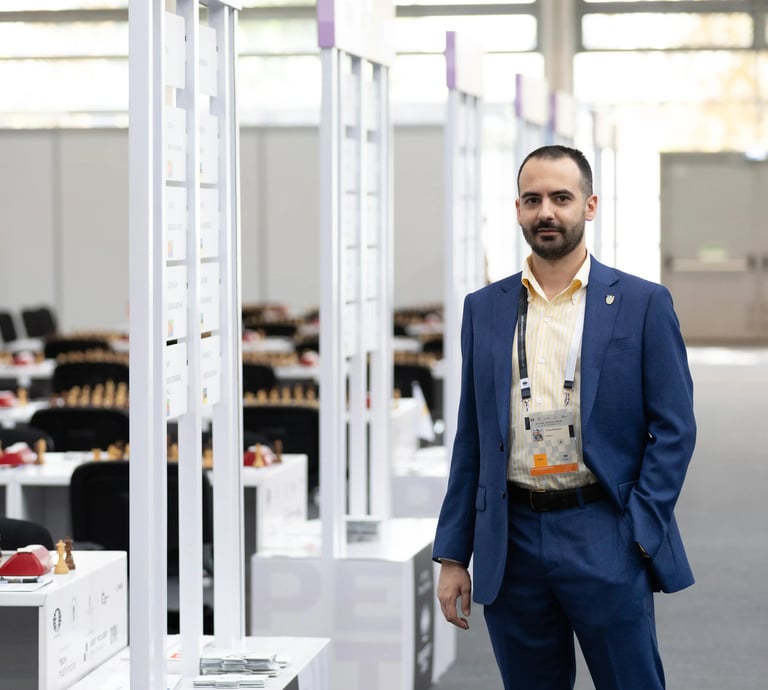 Chess media Vlad Ghita looking towards the camera at the 2024 FIDE Chess Olympiad in Budapest