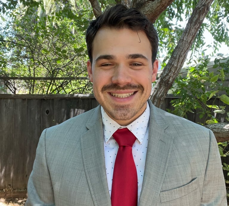 a man in a suit and tie smiling