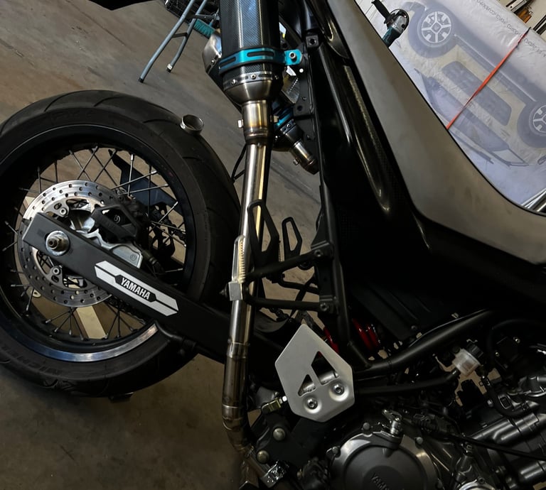 a motorcycle parked in a garage with a motorcycle