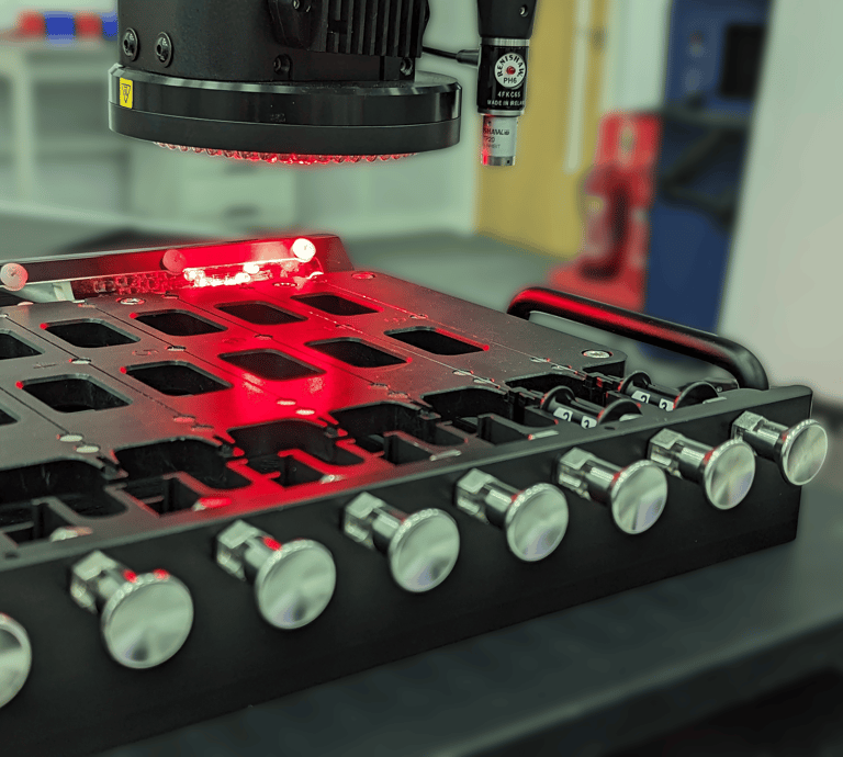Multi-nest metrology fixture holding small thin medical devices whilst being inspected by an optical CMM.