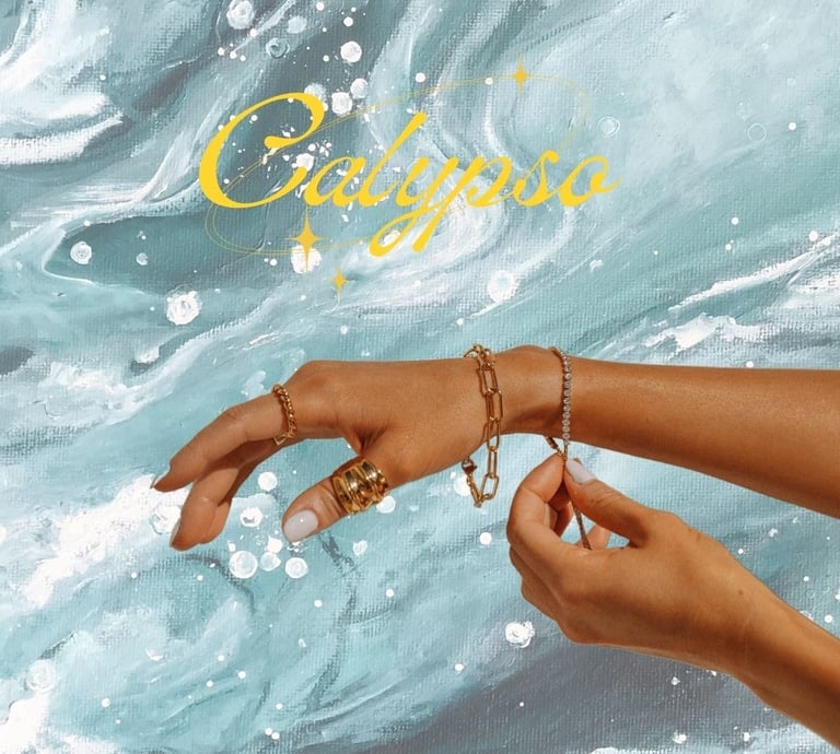 Elegant gold jewelry including rings and bracelets displayed on a hand over blue ocean wave art.