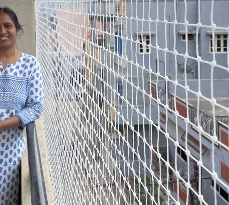 happy customer beside their pigeon net installed balcony in chembur mumbai