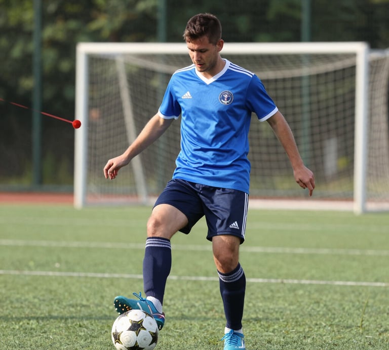 A vibrant indoor futsal match with players celebrating a goal under bright lights.