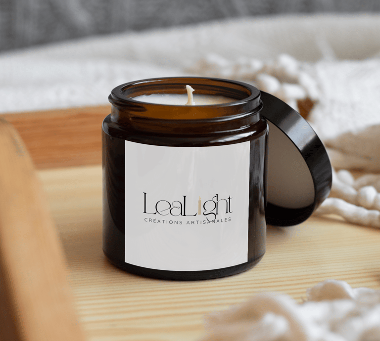 LeaLight handmade soy candle in an amber glass jar on a wooden tray with a cozy blanket.
