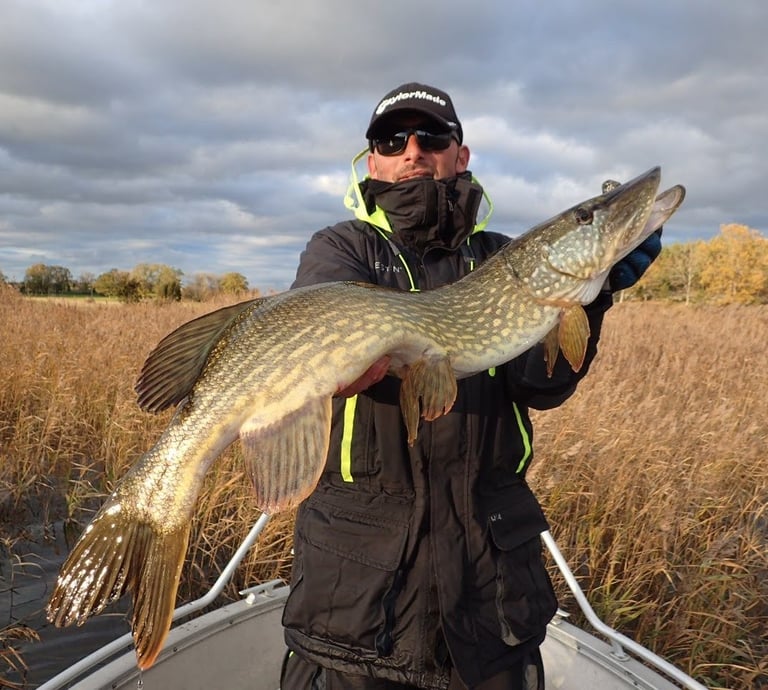 angler holding a pike 