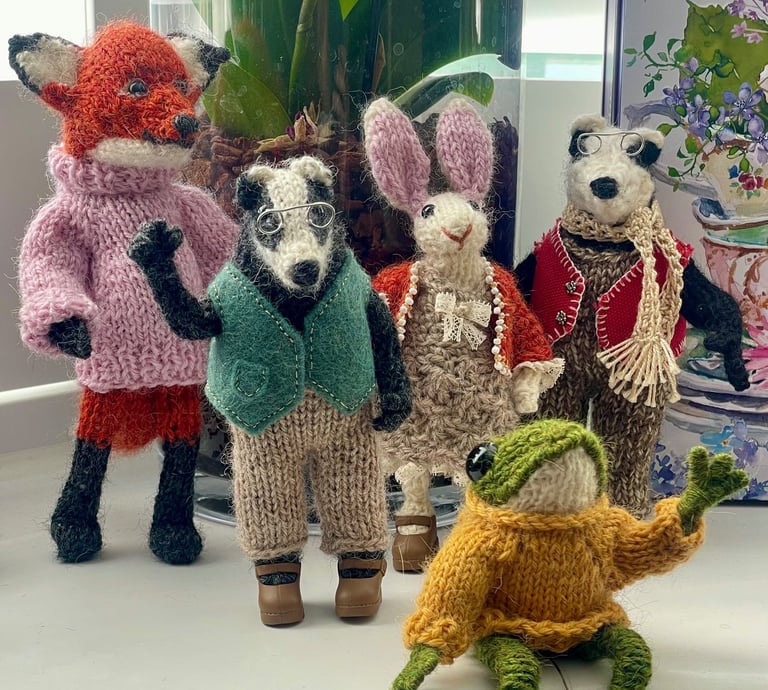 a group of knitted animals sitting on a counter