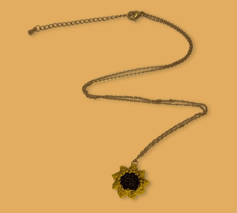 a necklace with a sunflower on it