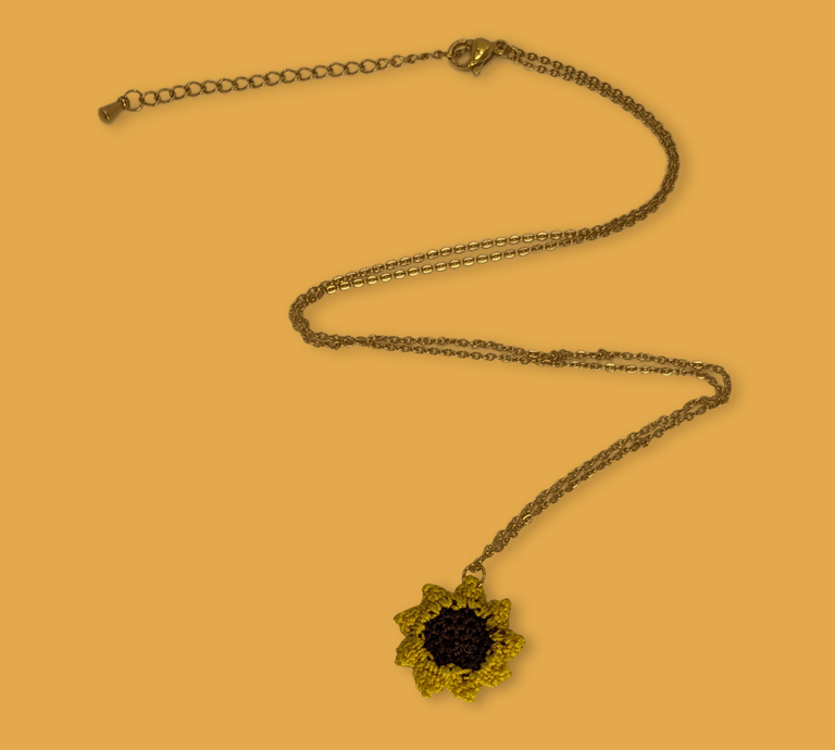 a necklace with a sunflower on it