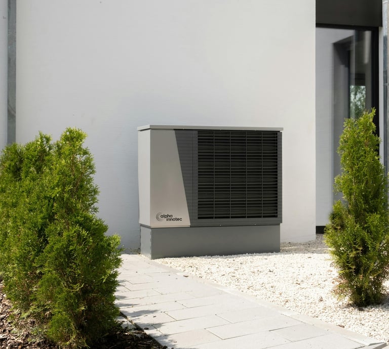 a small air conditioner sitting in front of a house