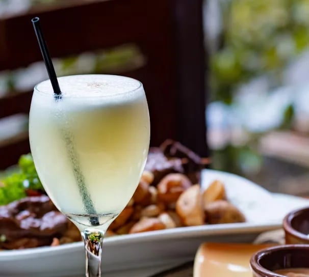 A pisco cocktail with seafood in Peruvian restaurant Lisbon Portugal