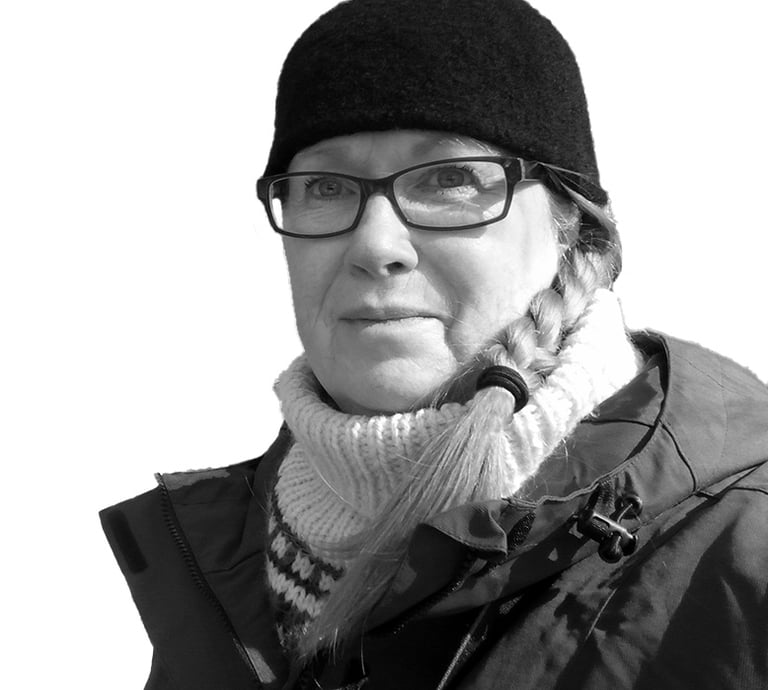 a black and white photo of a woman in a hat