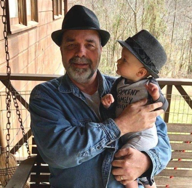 a man in a hat and a hat on a swing