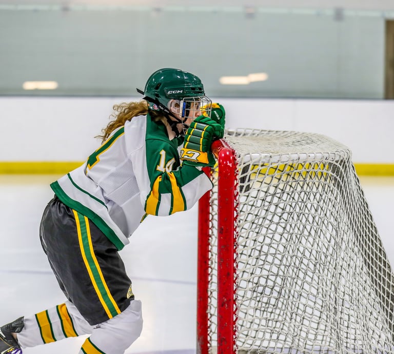 GMU Hockey player pushing a hockey net
