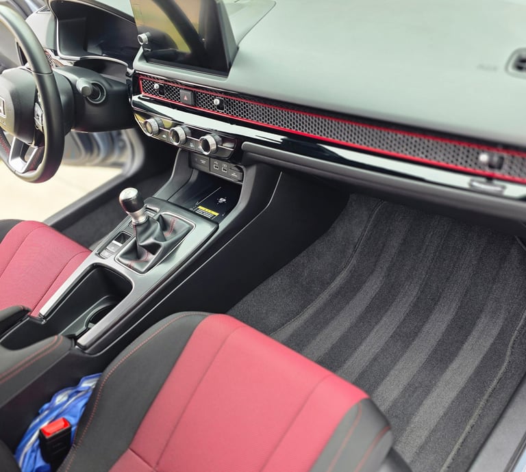 a car dashboard with a steering wheel and a steering wheel