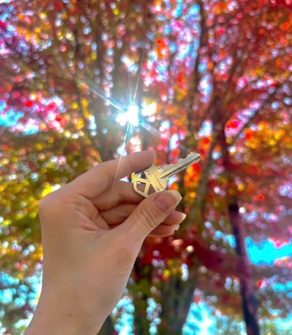 Metal car key duplication with fall tree in background in Canton, NC