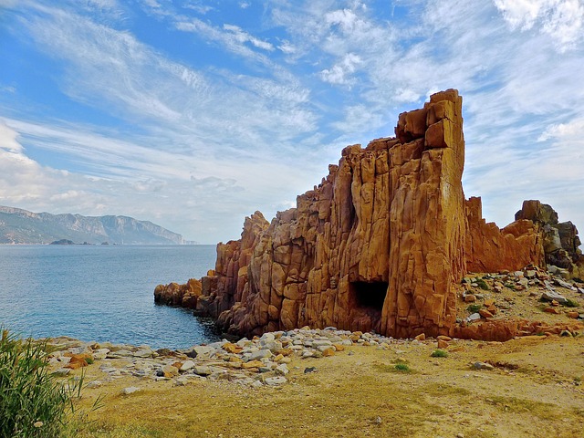 a cave in the middle of a rocky cliff