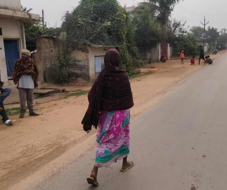 a lady is walking on the road