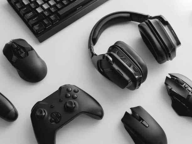 a keyboard, mouse, and headphones on a desk