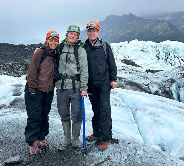 Al Belluche with his family stnading on a glacier