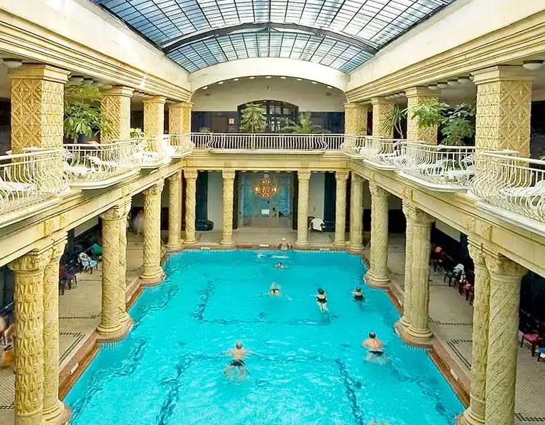 a large indoor swimming pool with a skylight