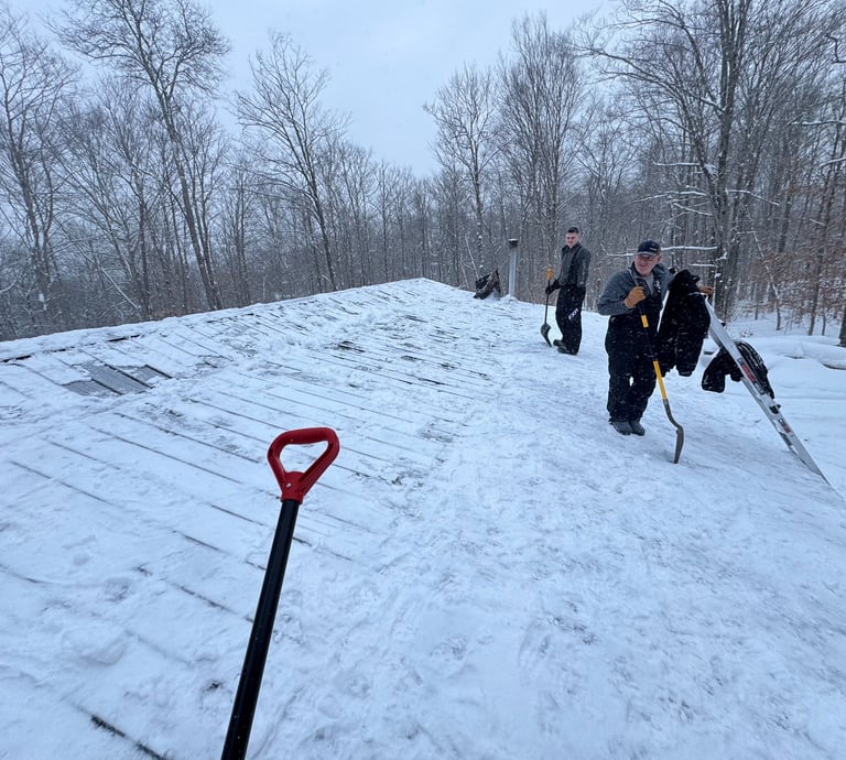 A crew of men shoveling a roof