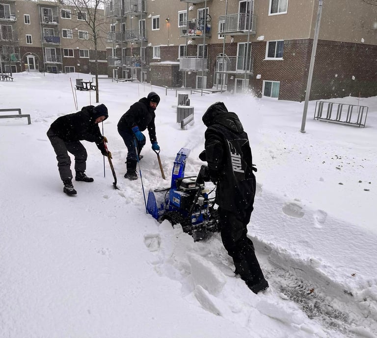a group of people are shoveling through the snow