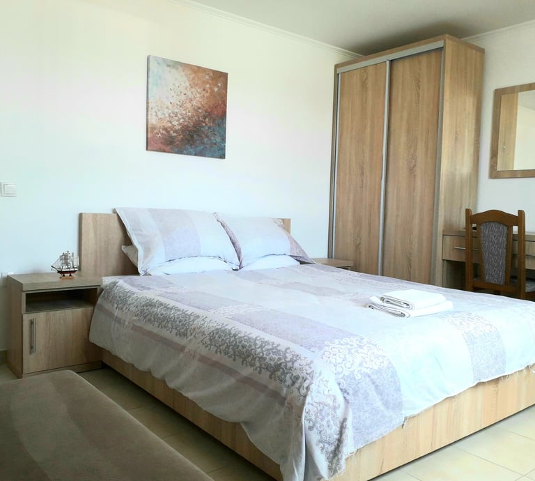 a bedroom with a bed and a desk