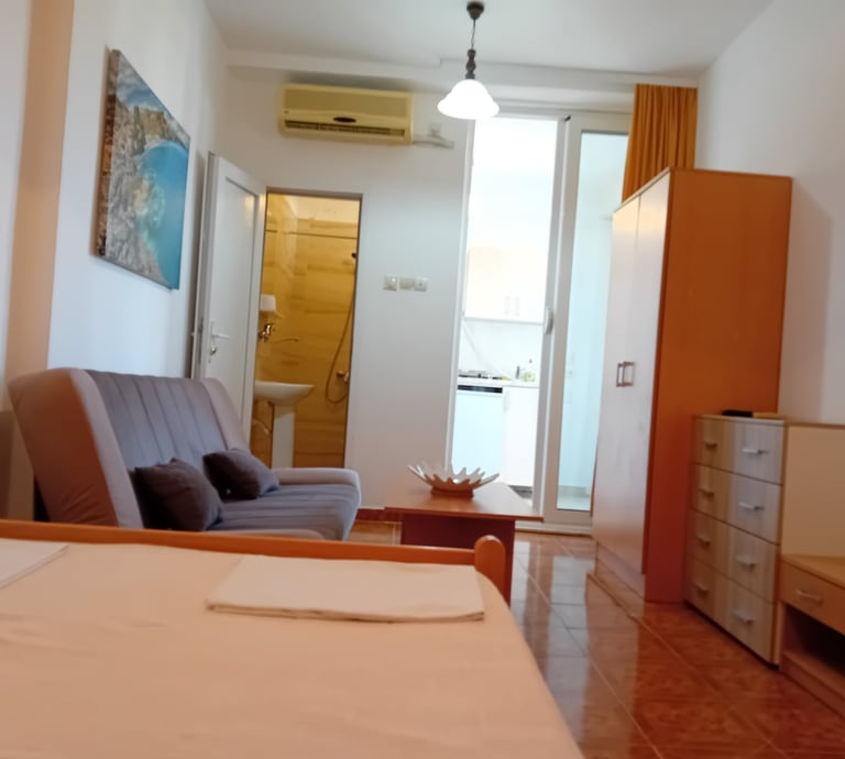 a bedroom with a chair and a couch