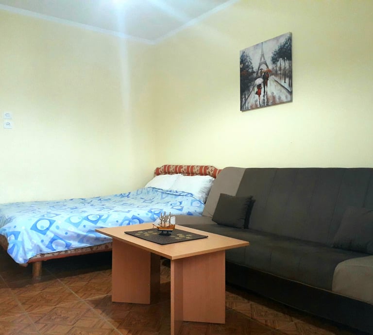 a couch with a bed and a table with a table with a table and a