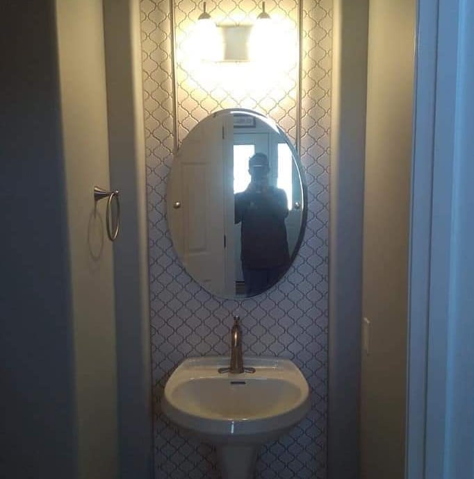 a person taking a selfie in a mirror in a bathroom