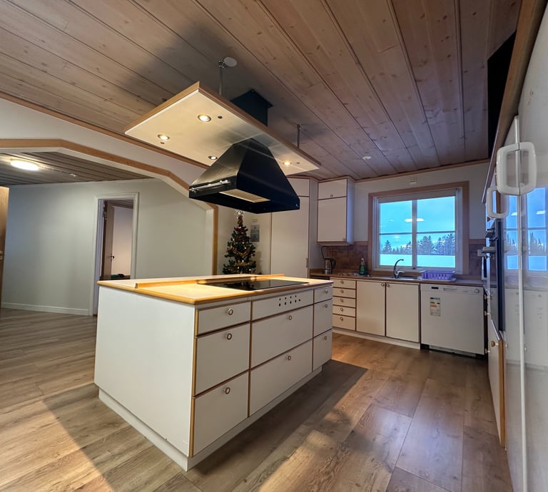 a kitchen with a stove top and Christmas tree