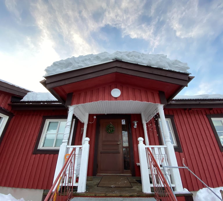 a red house with a red door and white stairs
