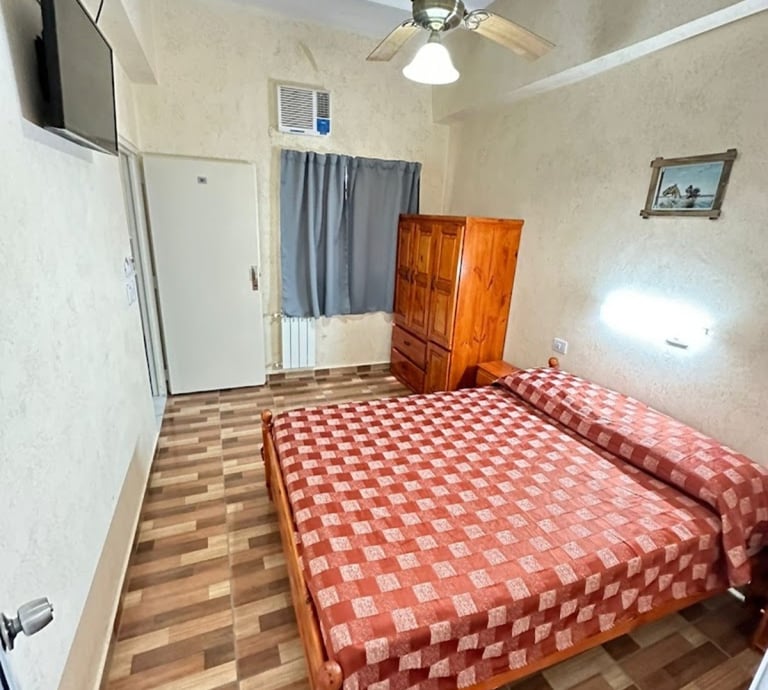 A room with a double bed.