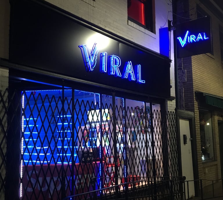 a storefront of a storefront door with a neon sign that says viral