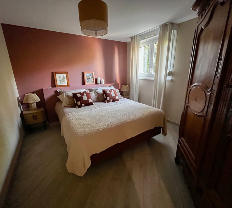a bedroom with a bed and a wooden cabinet