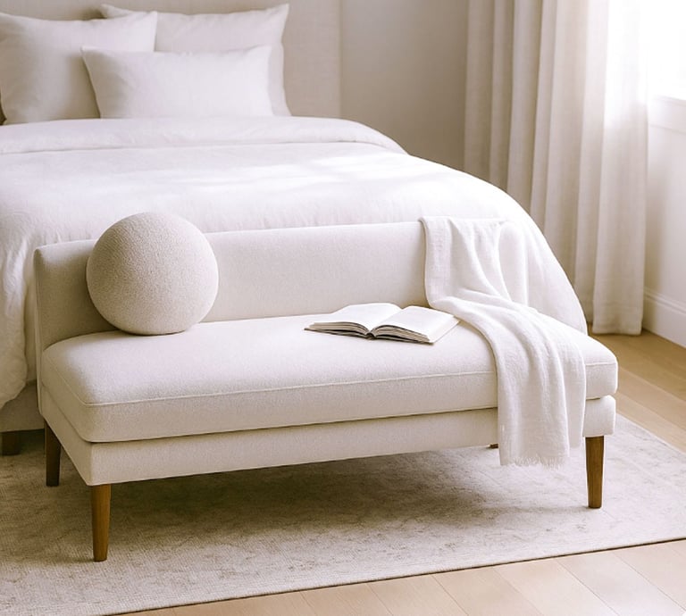 Compact linen settee in a cozy reading corner with natural shadows, a book, and a warm light atmosphere.