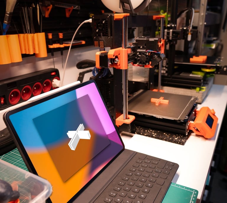 A modern tablet with keyboard on a workbench next to an active 3D printer in a maker workspace.
