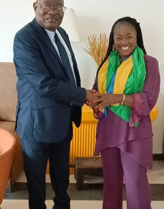 a man and woman shaking hands in a room