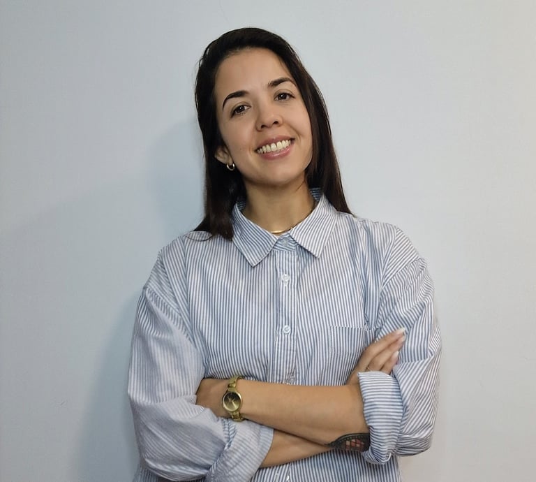 a woman psychologist in a blue shirt and a watch on her wrist