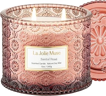 a candle with a pink candle in a glass jar