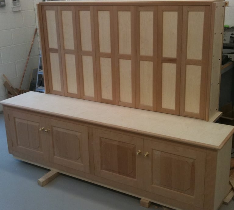 A TV and Media Storage unit. The TV is mounted behind folding doors.