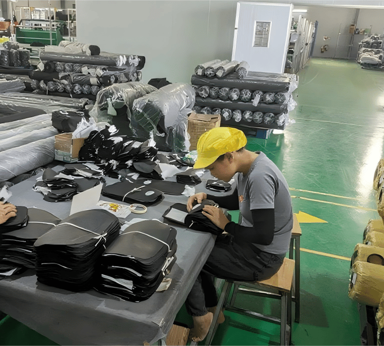 A King Fly team member performing meticulous quality control on a custom bag production line.