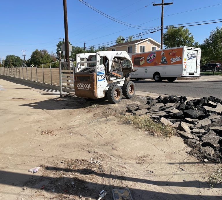 Fence and gate entrance under construction with Bobcat skid steer