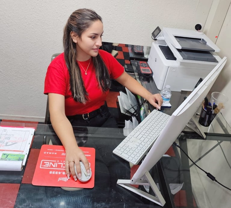Fast Tire Shop customer service representative assisting clients at the front desk in East Los Angel