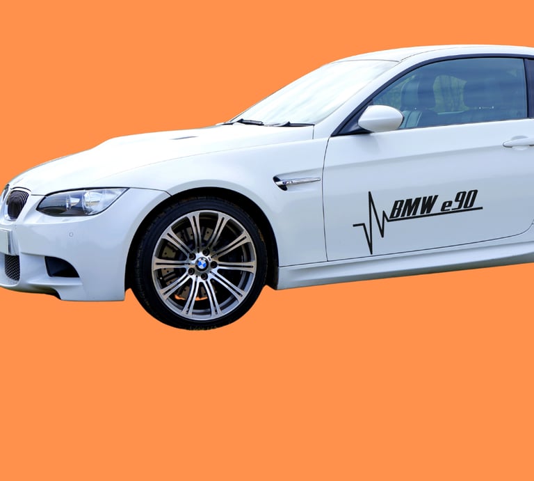 White BMW E90 M3 coupe with custom heartbeat door decals on an orange background.
