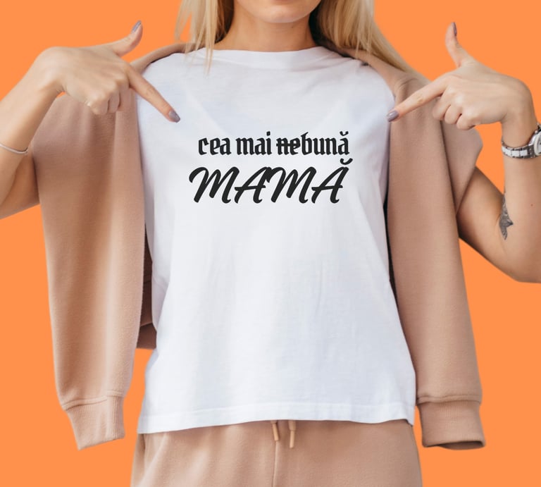 Woman in white t-shirt with Romanian text 'cea mai nebuna MAMA' on an orange background.