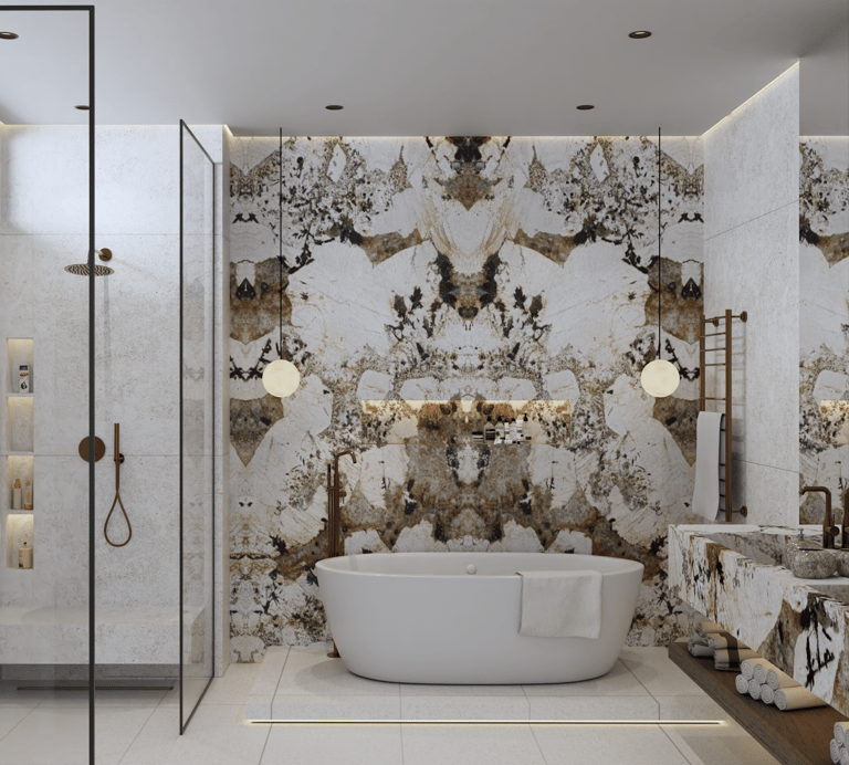 Luxurious bathroom with a white freestanding bathtub against a Patagonia Marble wall.