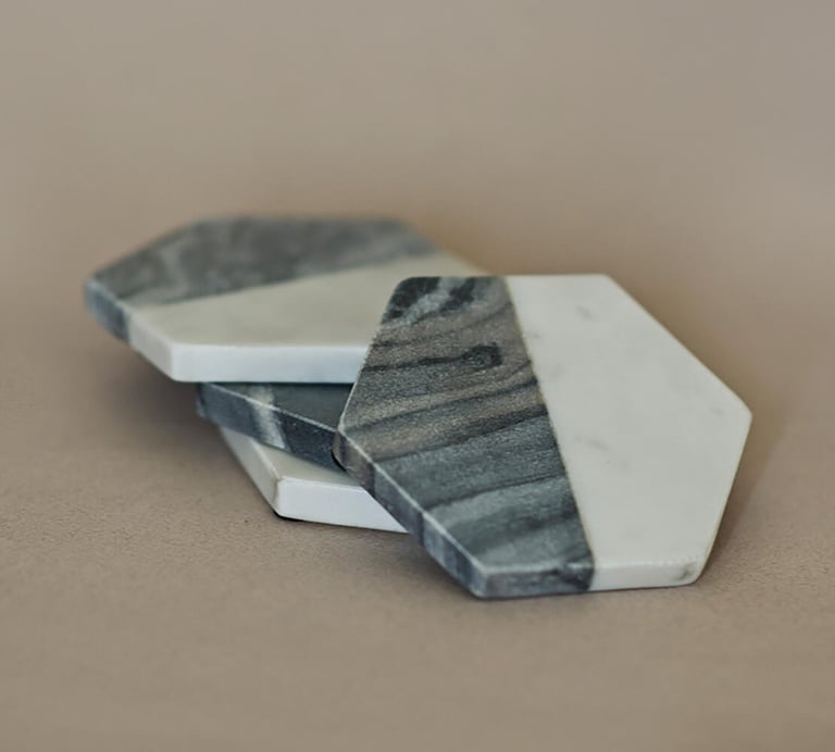 a pair of marbled coasters with a marbled surface