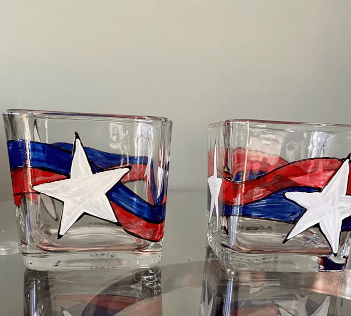 two glasses candle with a american patriotic flag on them