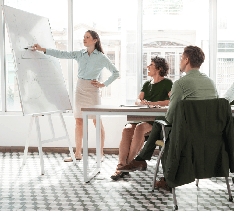 a woman in a business suit is standing in front of a white boardroom